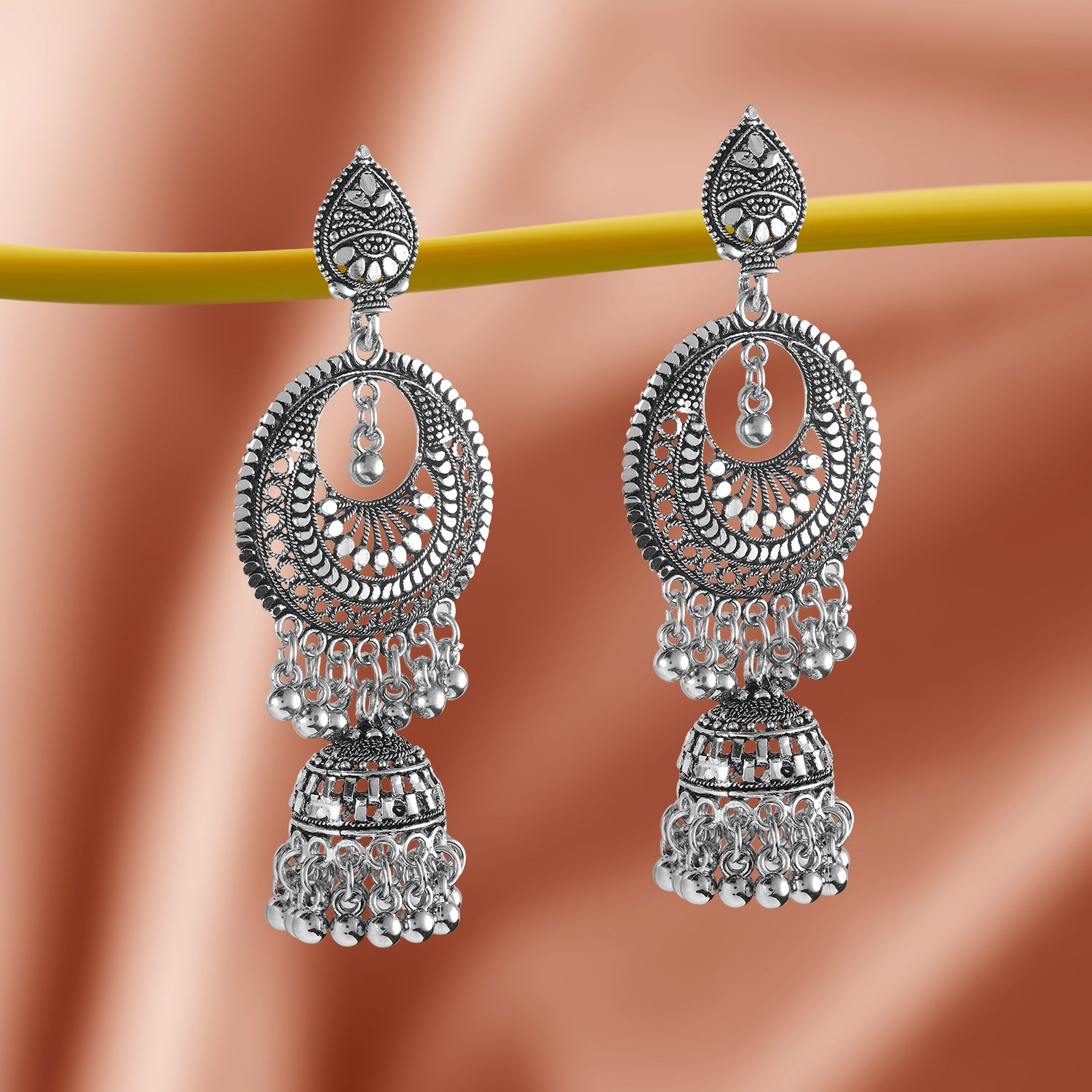 oxidized jhumka earrings peach background