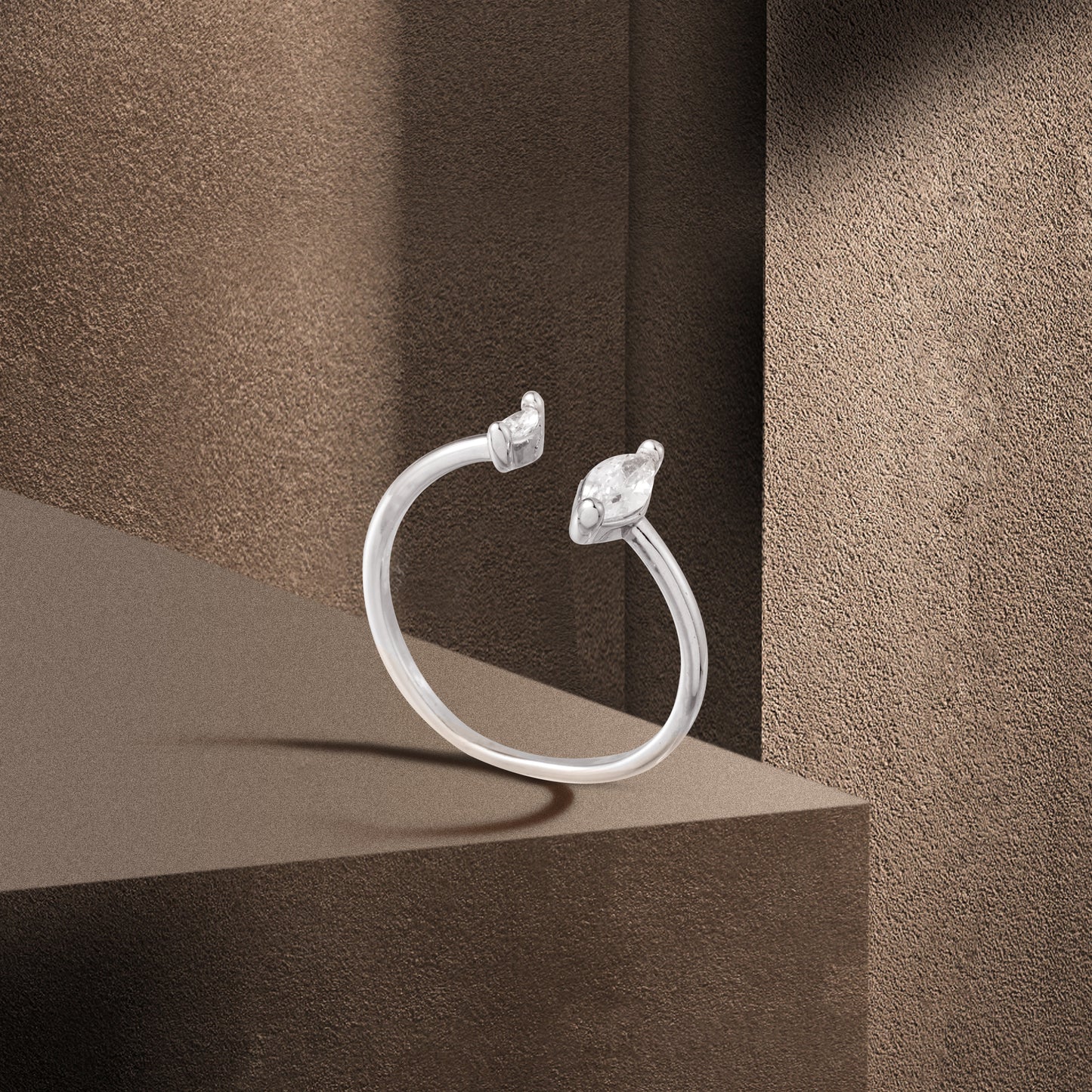 silver water drop ring brown background