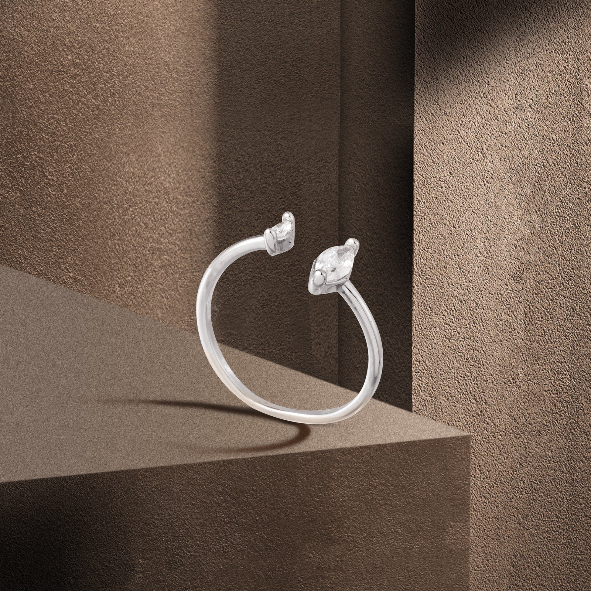 silver water drop ring brown background