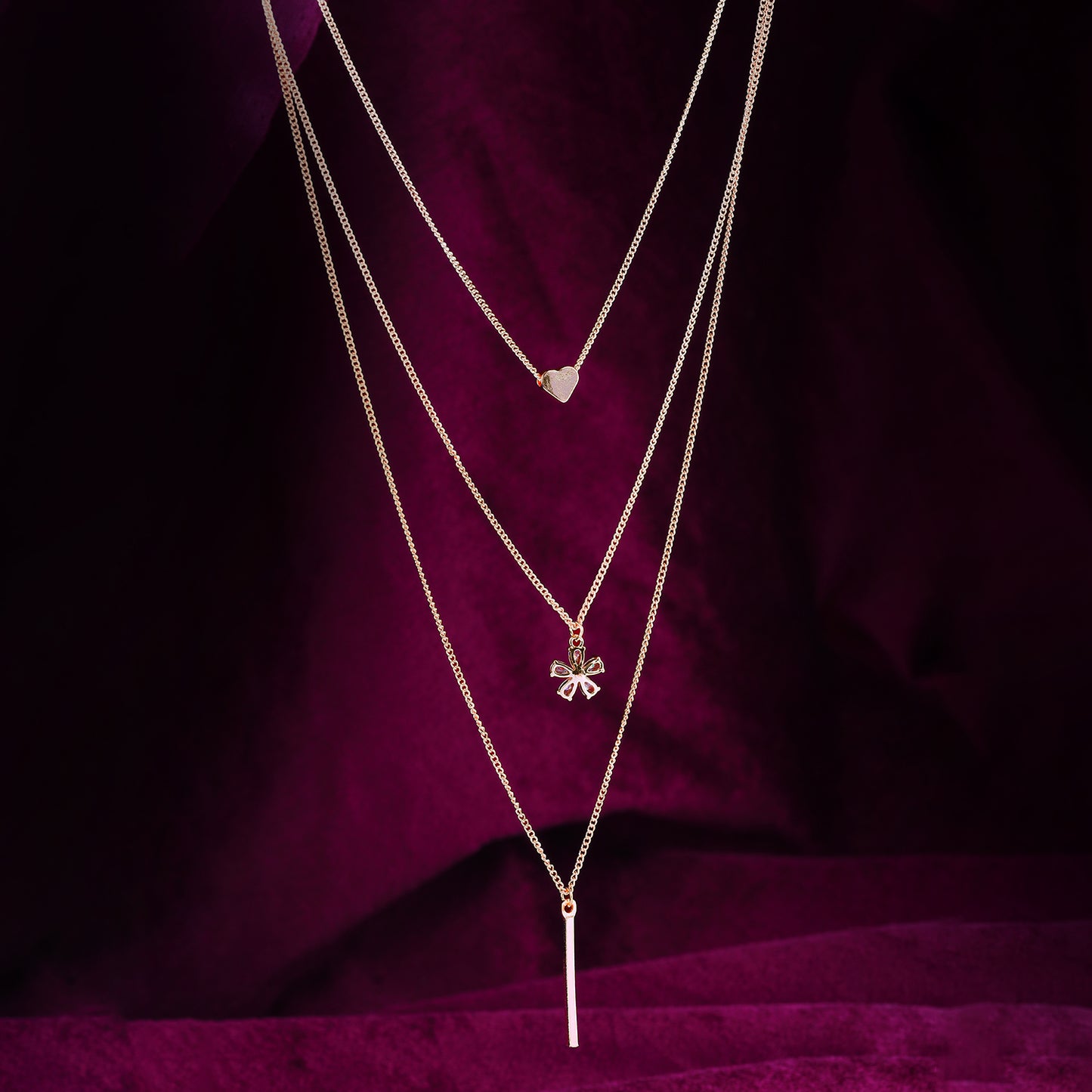 stylish multi layered necklace maroon background