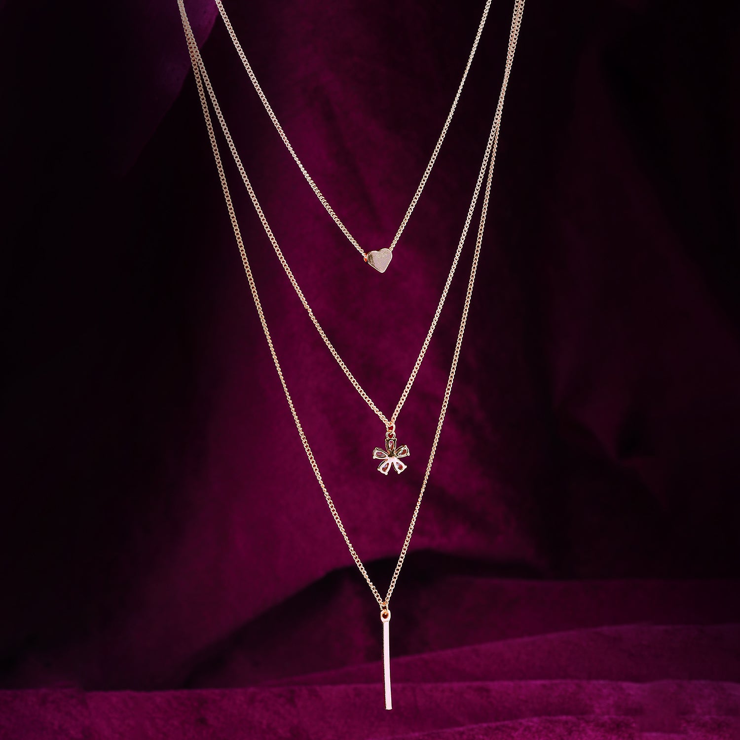 stylish multi layered necklace maroon background