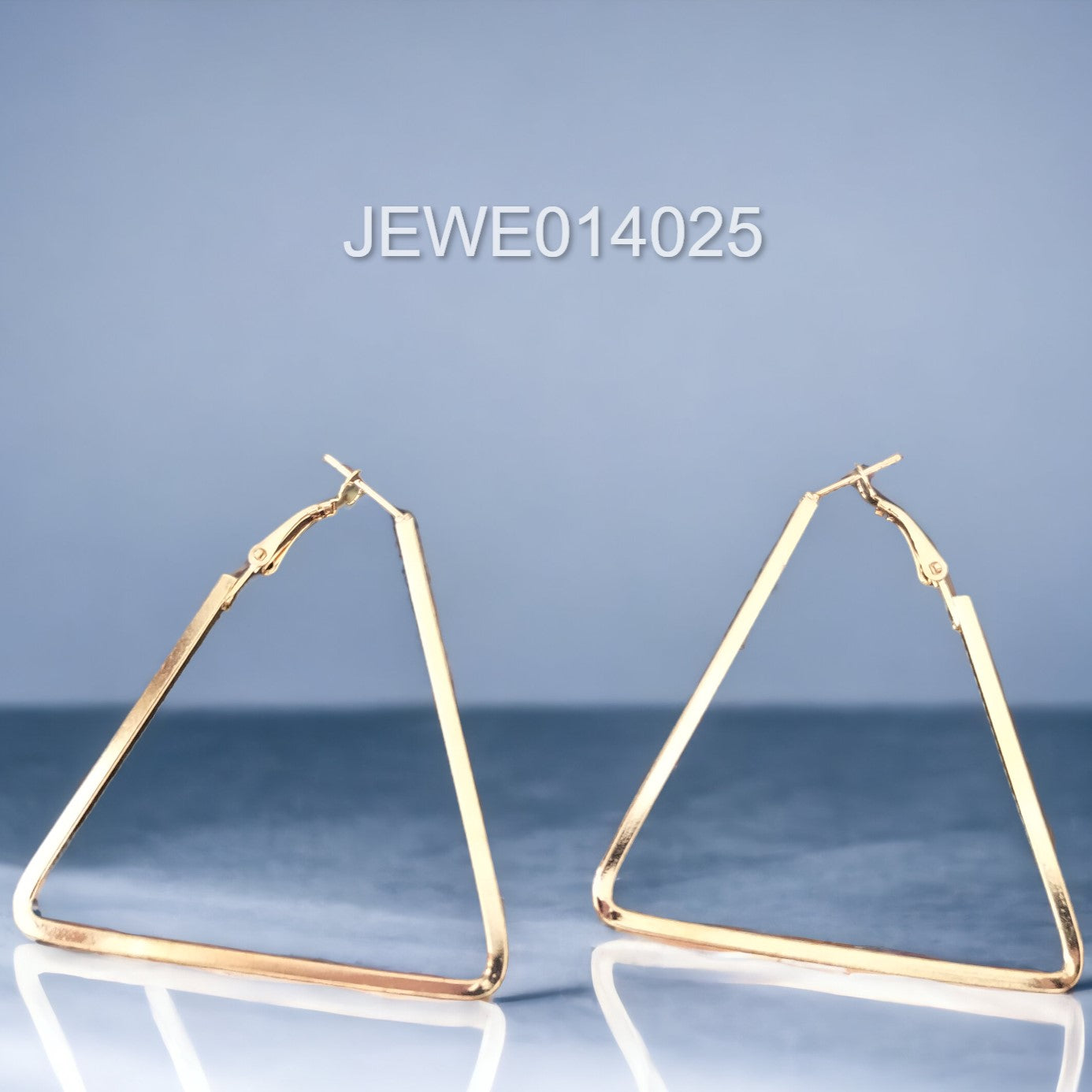 triangle hoop earrings light blue background