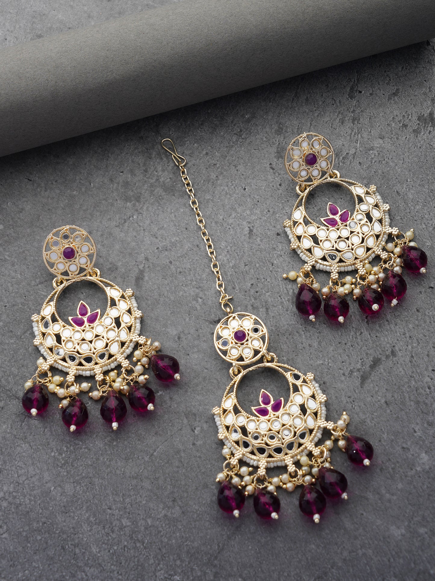 purple earring and maang tikka grey background