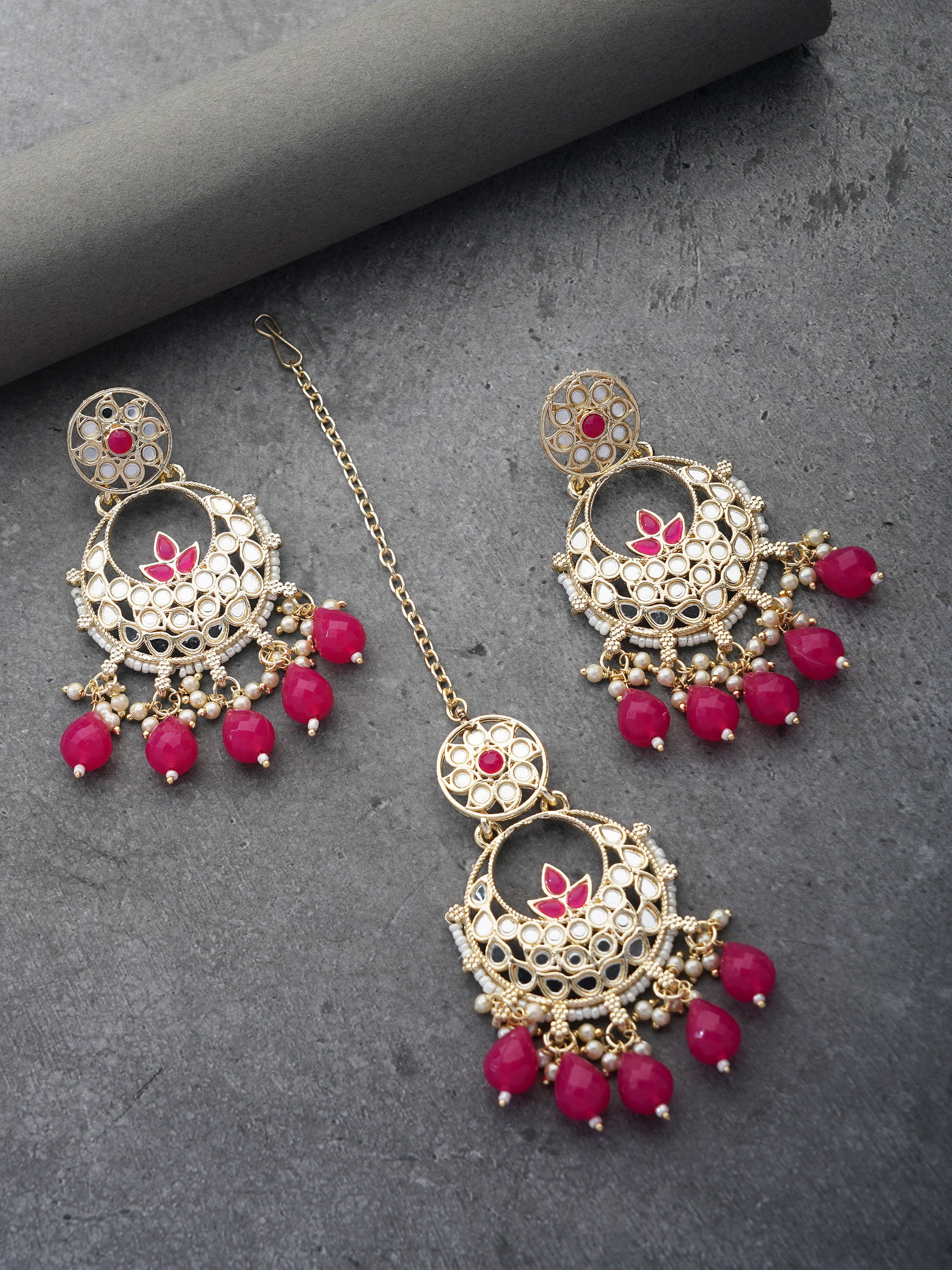 magenta earring and maang tikka grey background