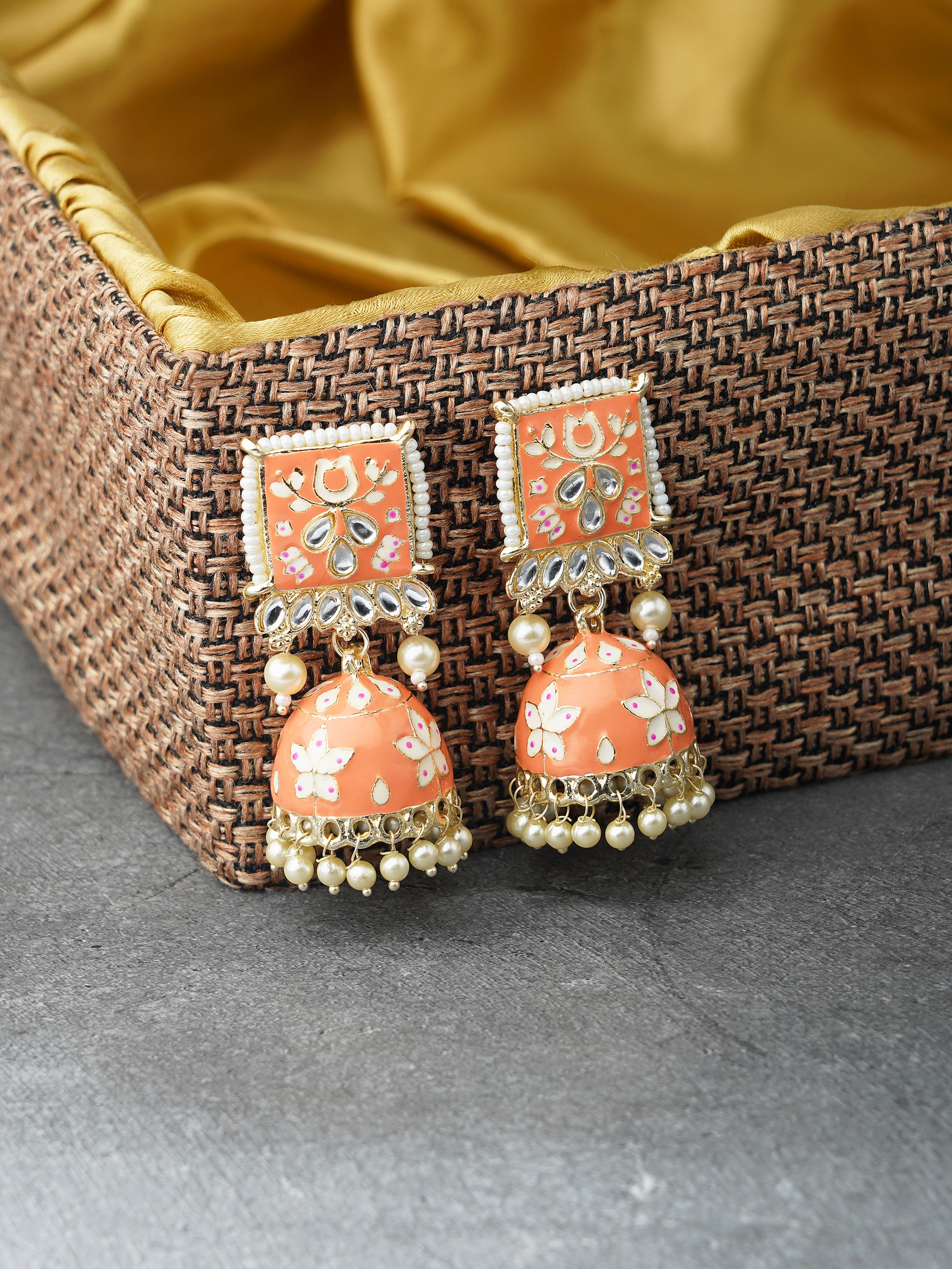 minakari peach jhumka earrings broen background