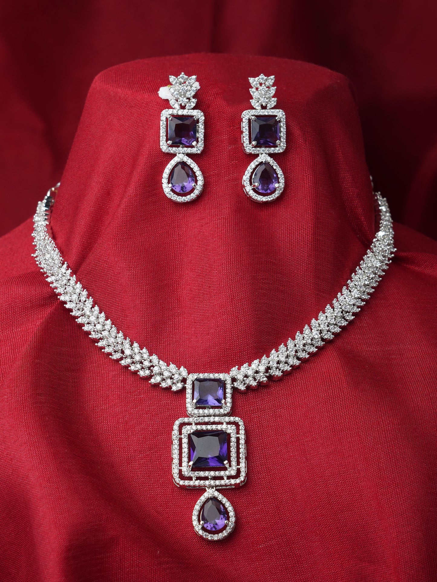 purple american diamond necklace red background