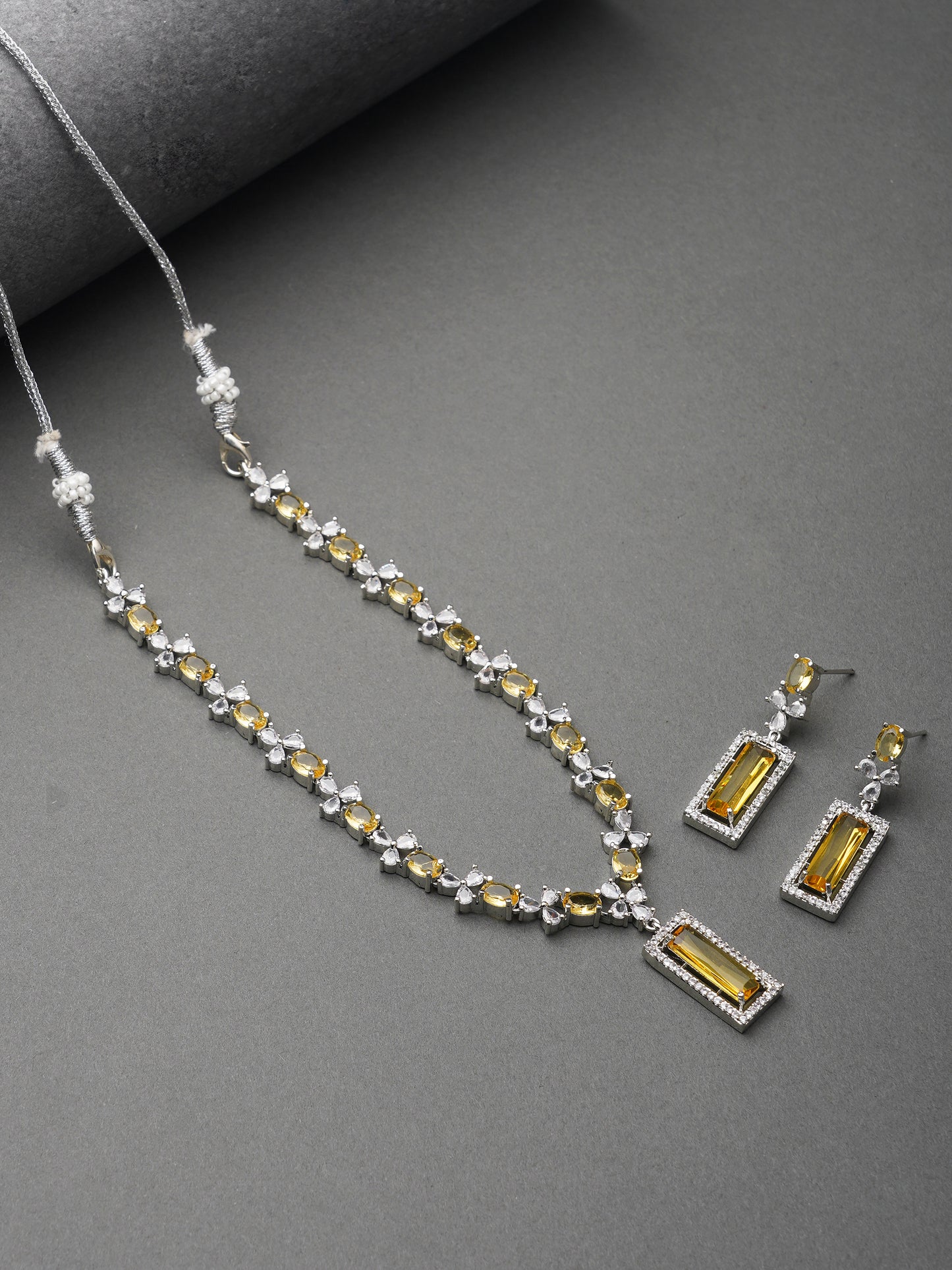 american diamond stone yellow necklace grey background