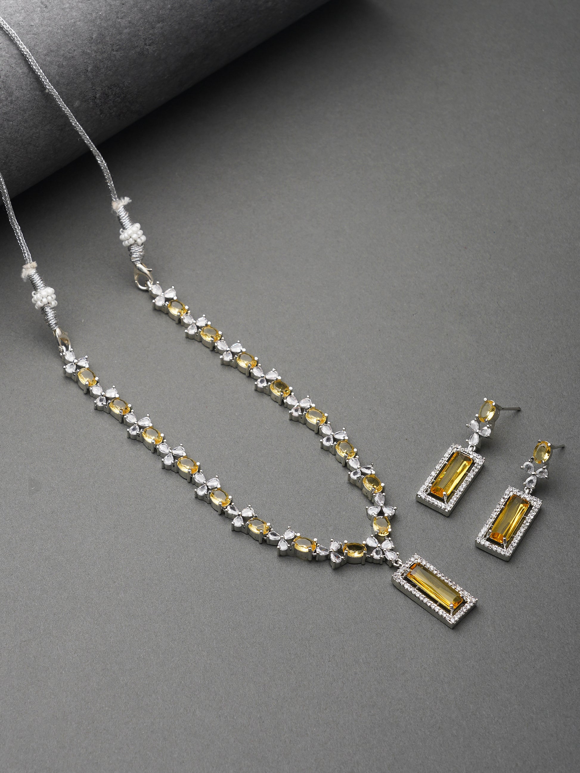 american diamond stone yellow necklace  grey background