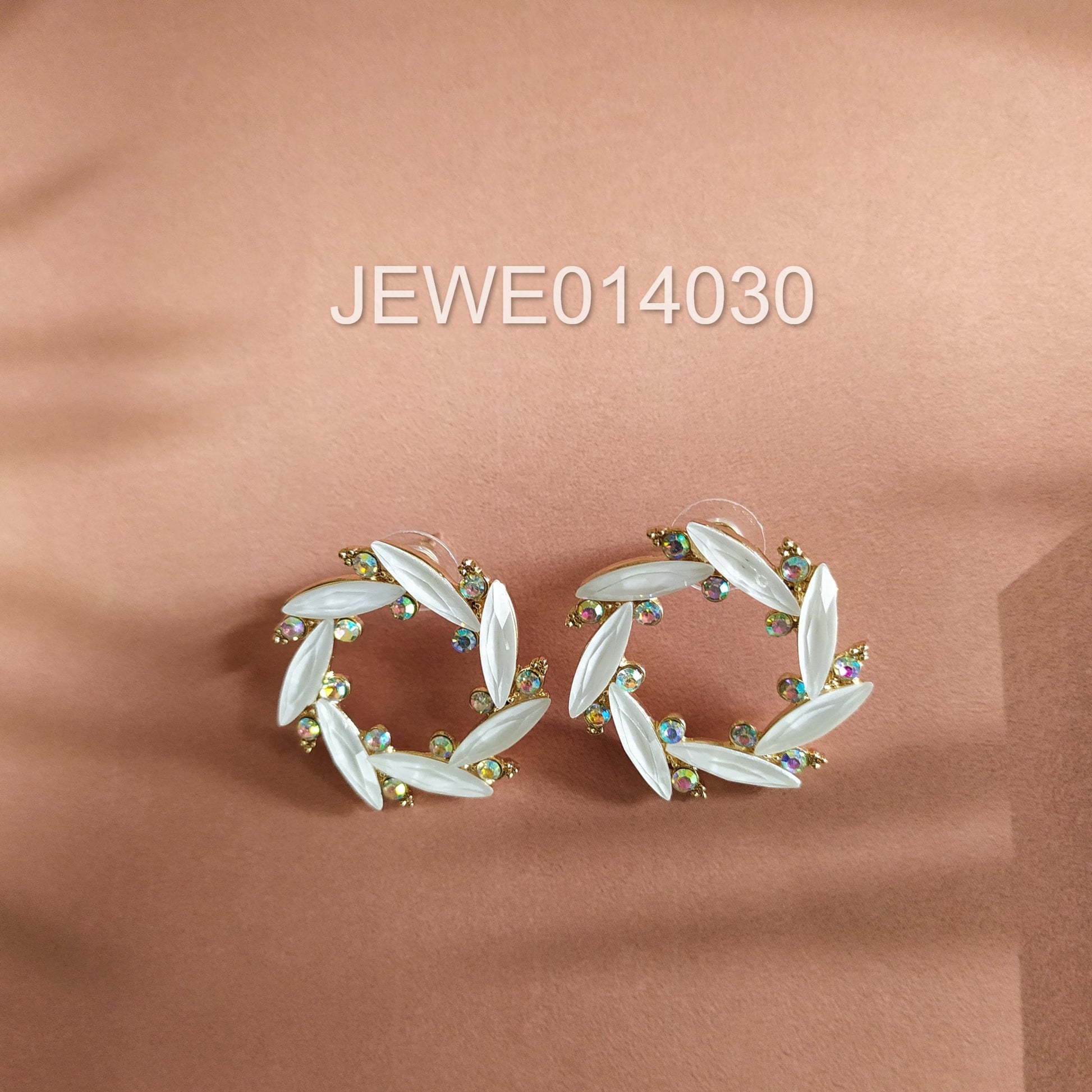white crystal stud earring peach background