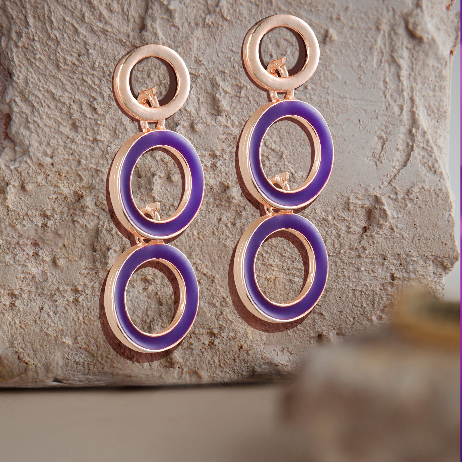 round purple and gold earring stone background