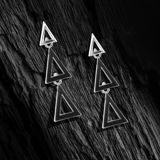 silver dangling triangle stud earrings black background