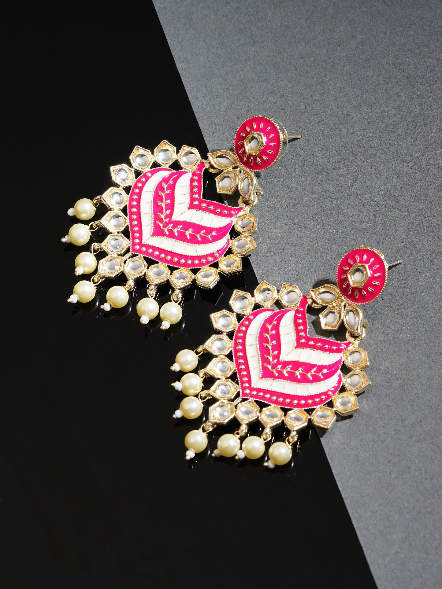 pink kundan earrings black background