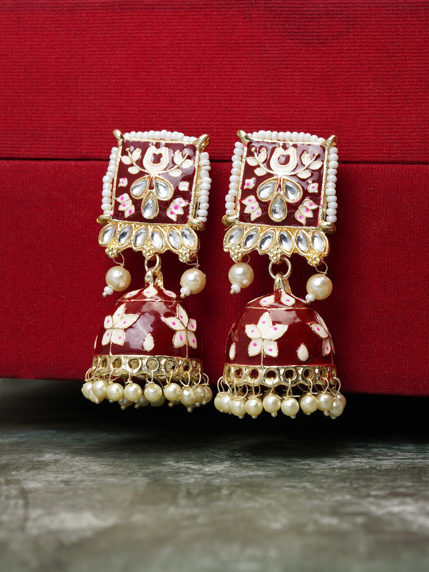 minakari maroon jhumka earrings red background