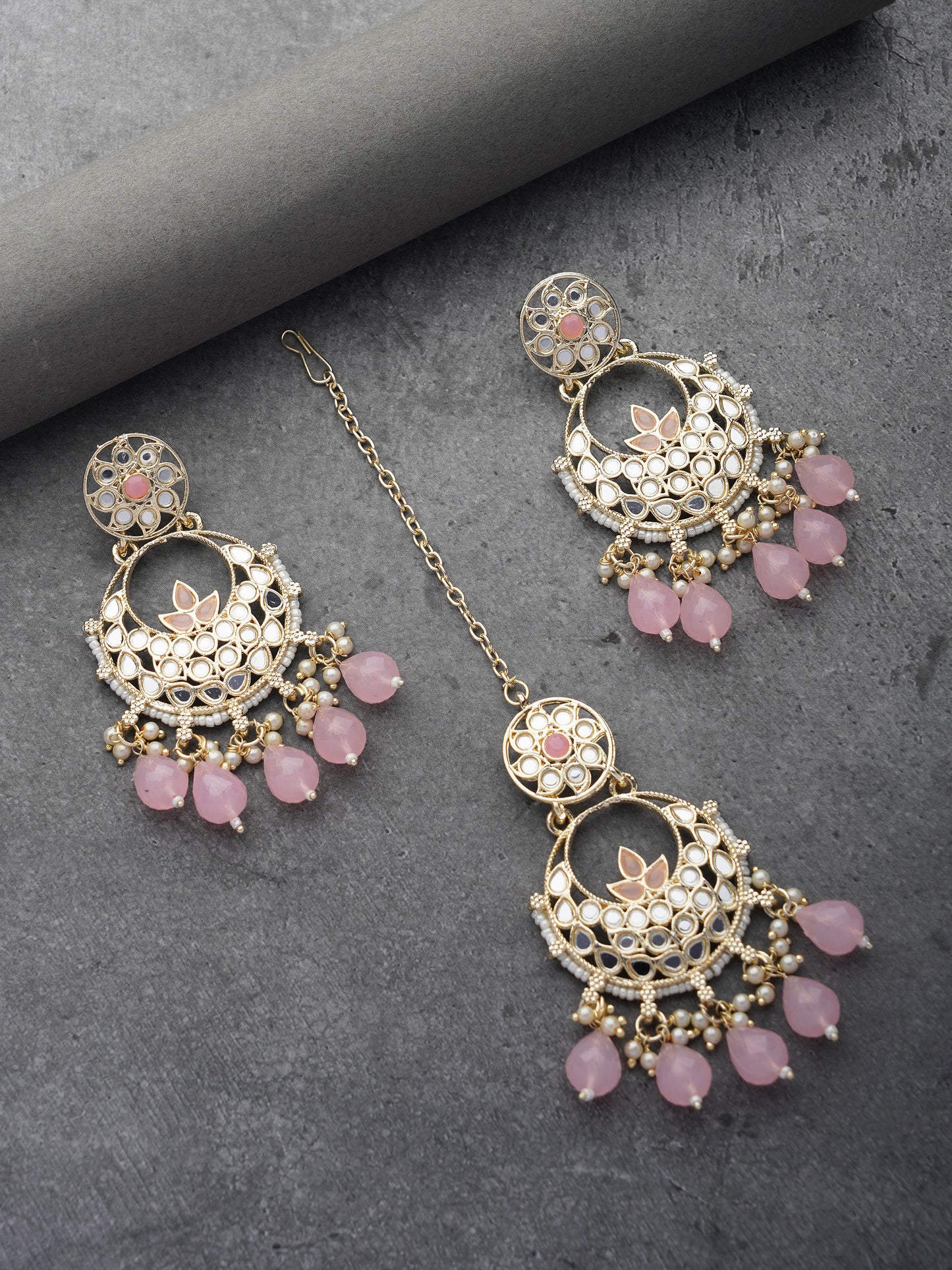 light pink earring and maang tikka grey background