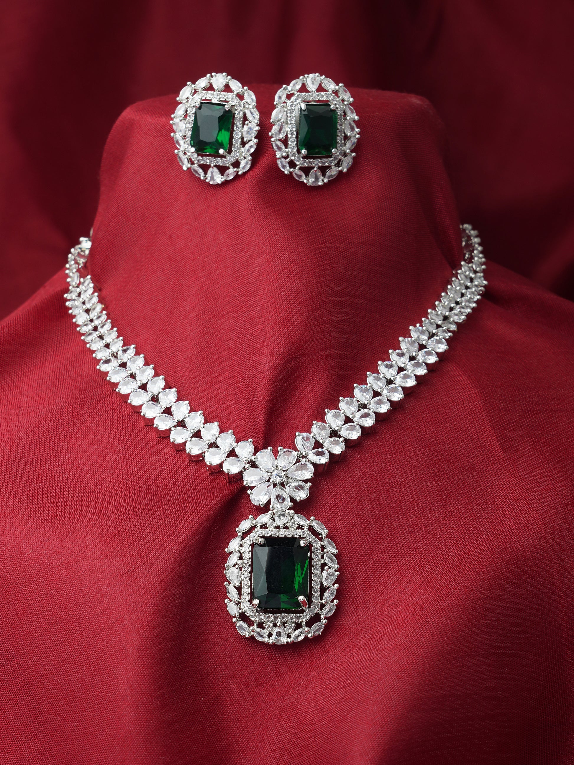 green stone american diamond necklace set red background