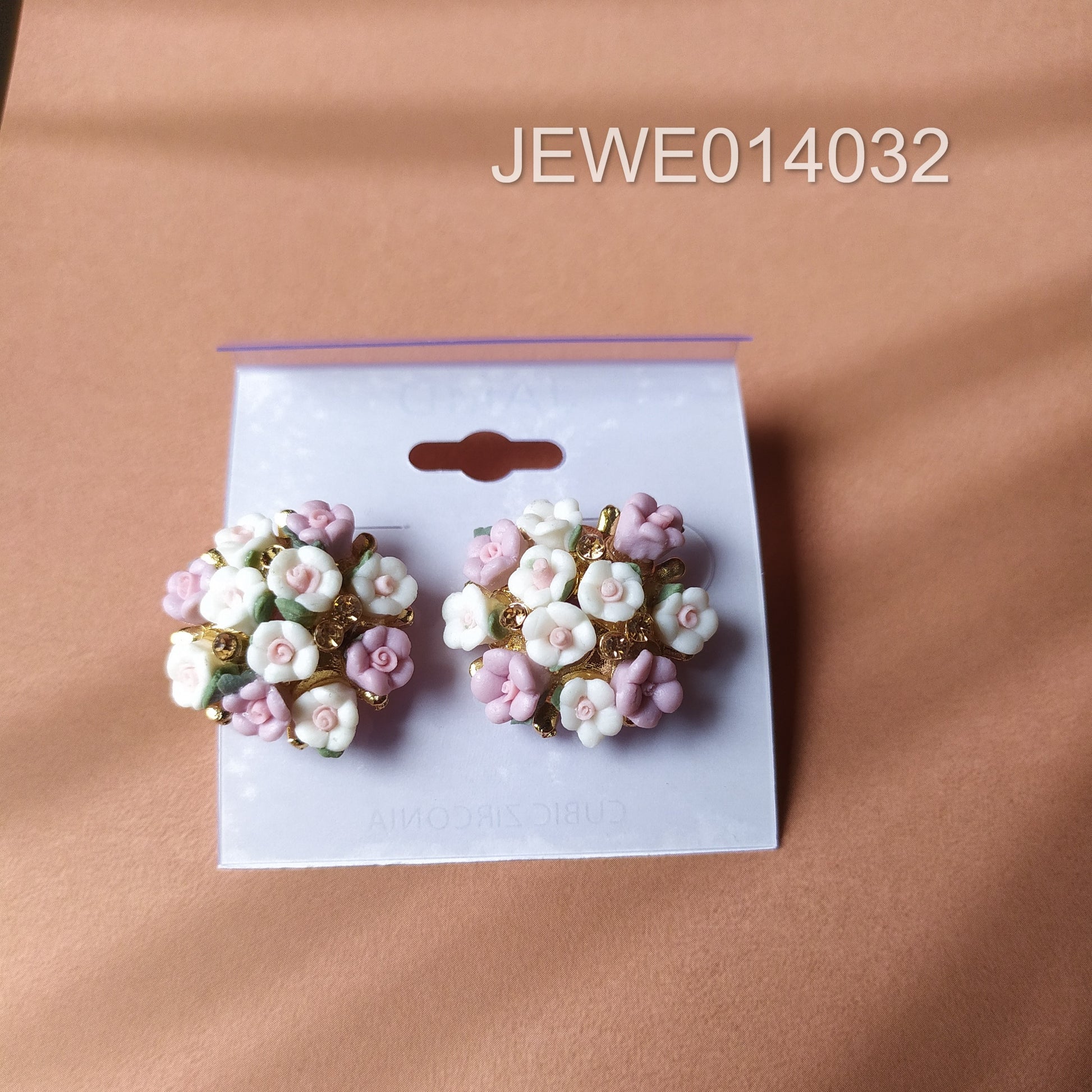 white and purple flower stud peach background